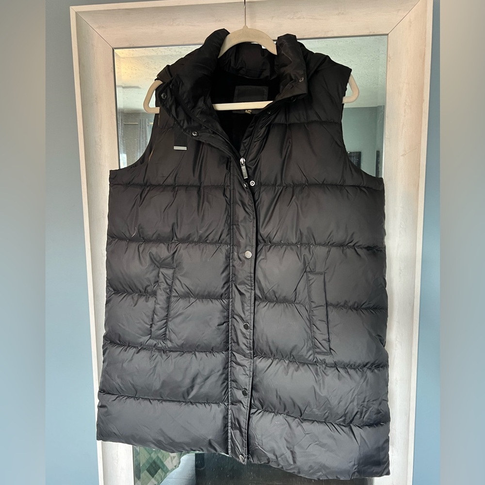 Weatherproof long puffer vest with detachable hood.